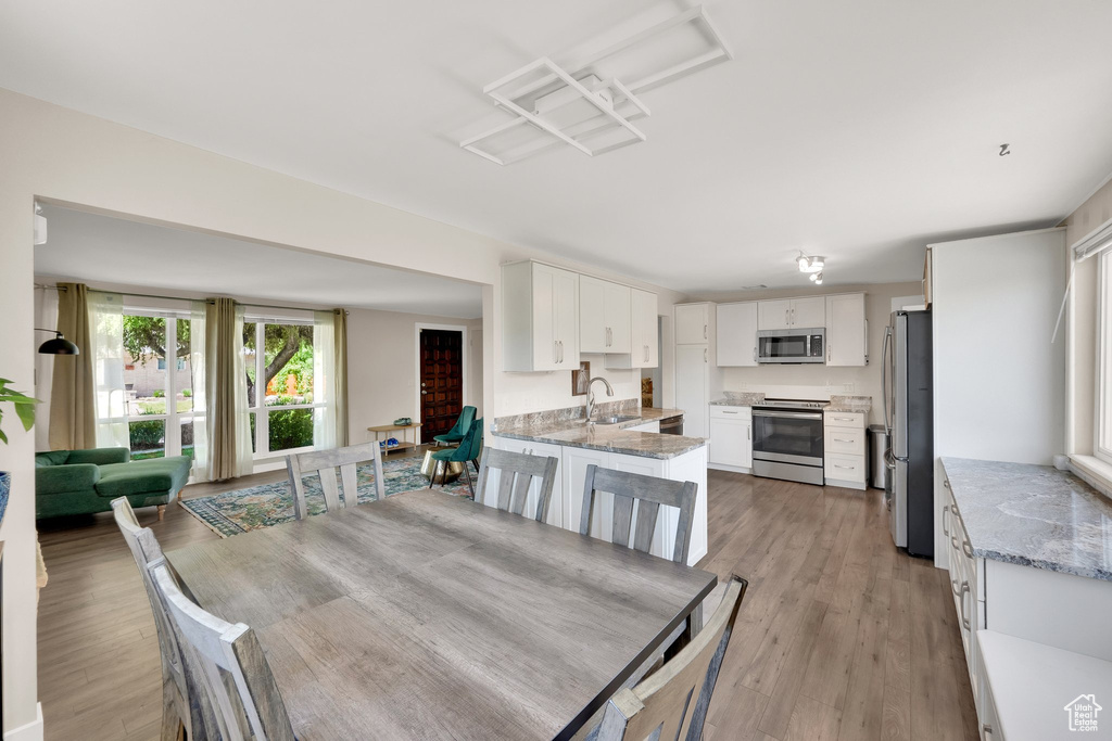 Dining area with light wood-style floors