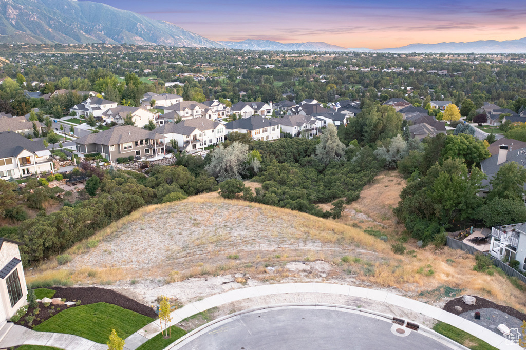 Aerial overview of property's location featuring a mountain backdrop and nearby suburban area