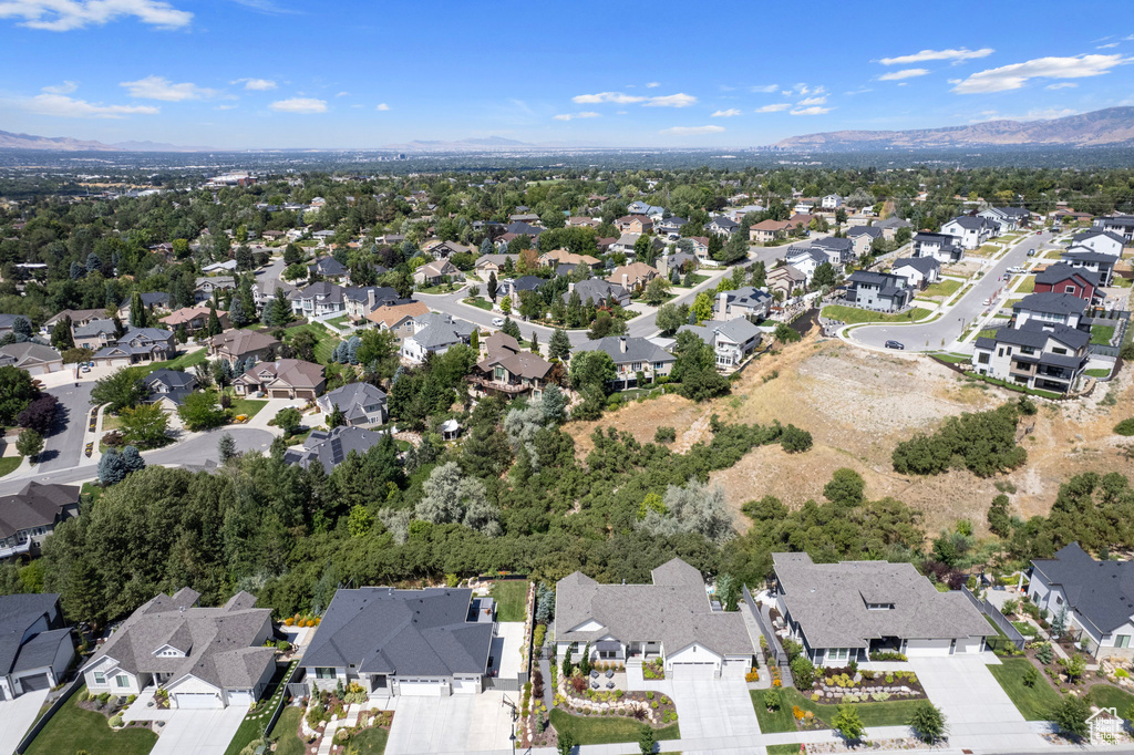 Aerial overview of property's location with nearby suburban area and a mountainous background