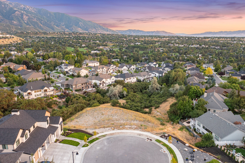 Aerial view of property and surrounding area with mountains and nearby suburban area