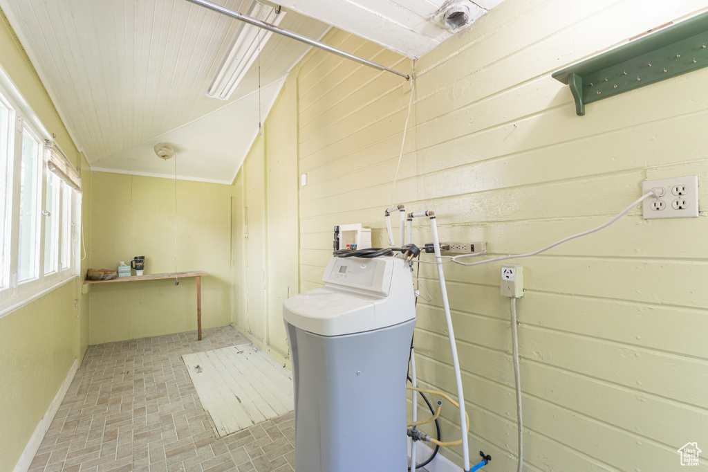 Washroom featuring brick patterned flooring and hookup for a washing machine