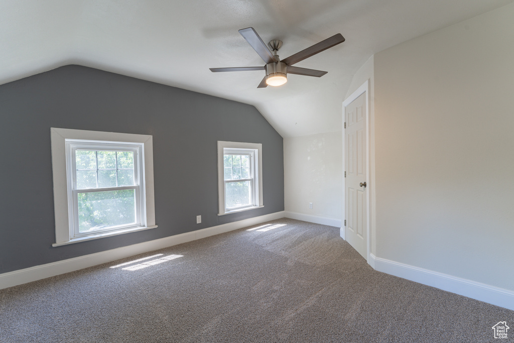 Bonus room featuring a ceiling fan, healthy amount of natural light, vaulted ceiling, carpet, and baseboards