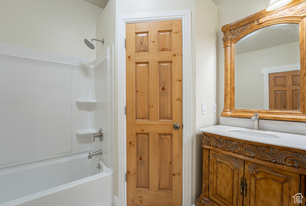 Bathroom featuring vanity and washtub / shower combination