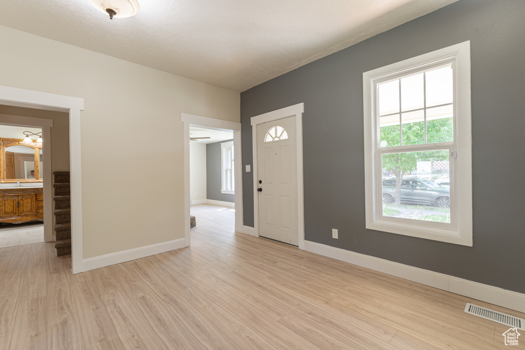 Entryway with light wood-type flooring, plenty of natural light, and baseboards