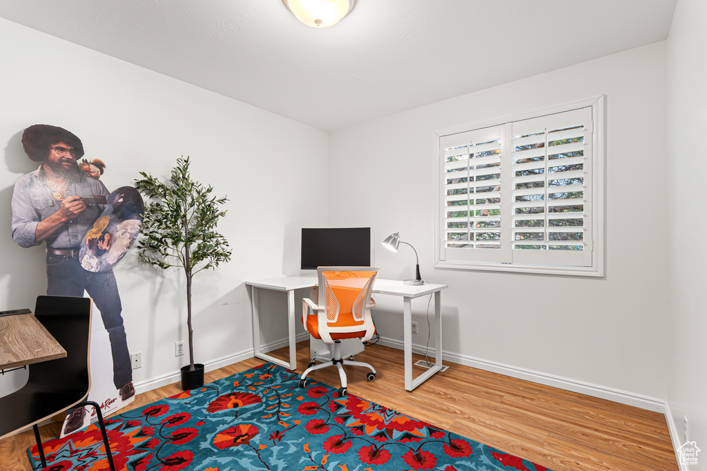 Office featuring wood finished floors and baseboards