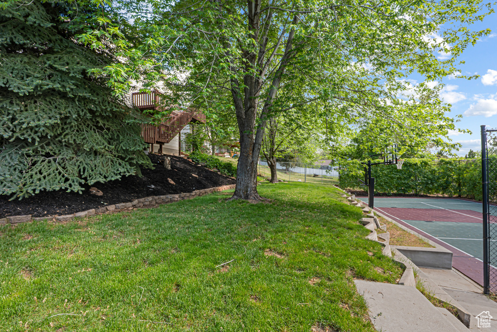 View of yard with basketball court