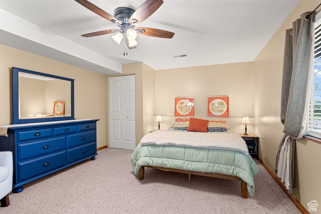 Bedroom featuring carpet floors, baseboards, and a ceiling fan
