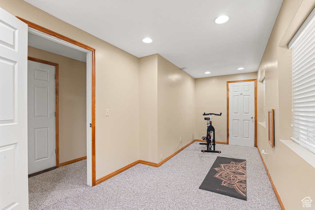 Exercise area featuring baseboards, carpet, and recessed lighting
