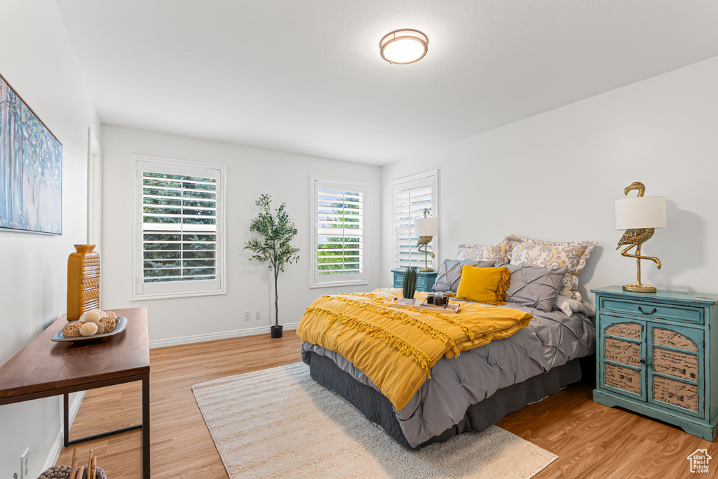 Bedroom with light wood-type flooring and baseboards