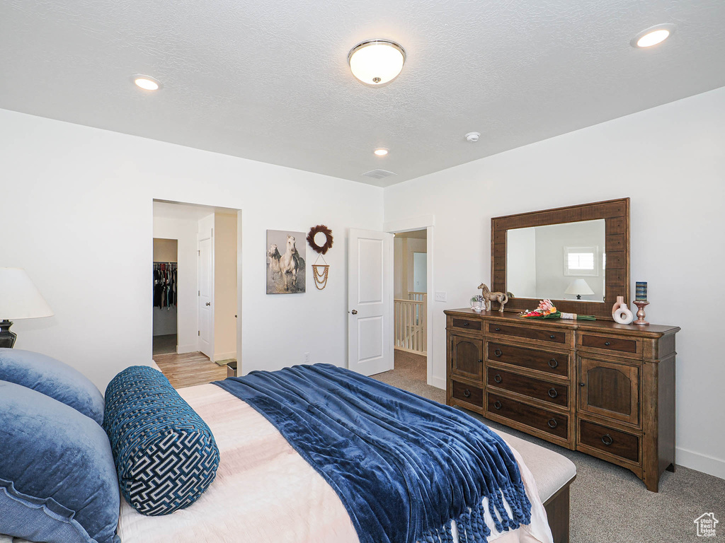 Bedroom with light carpet, baseboards, and recessed lighting
