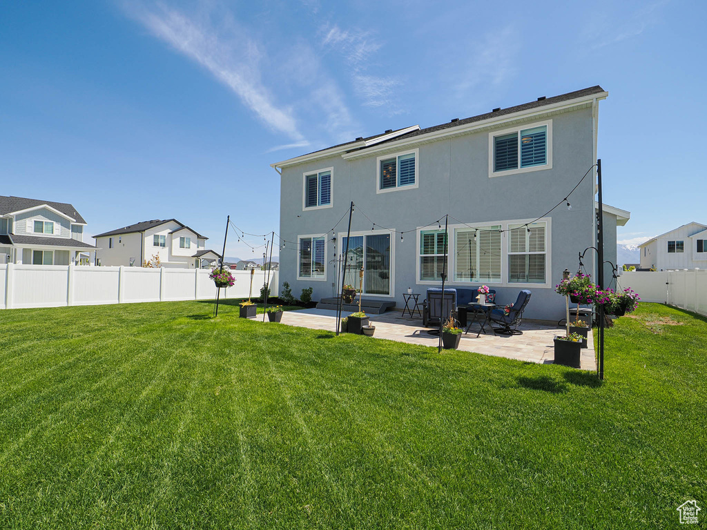 Rear view of property with stucco siding and a patio