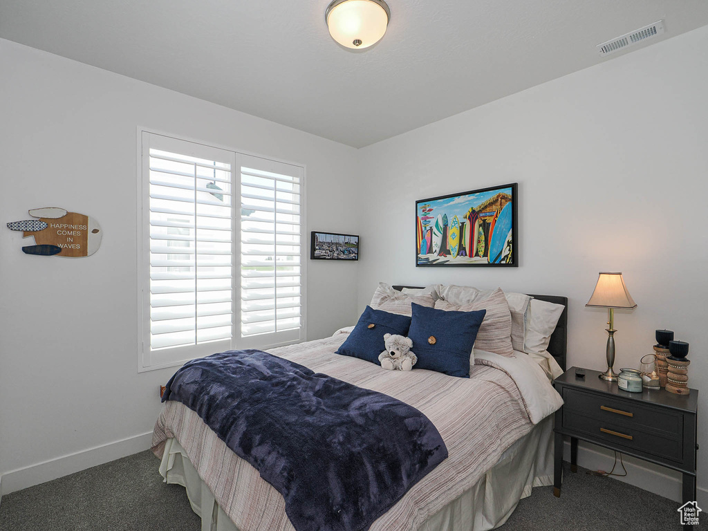 Carpeted bedroom featuring baseboards