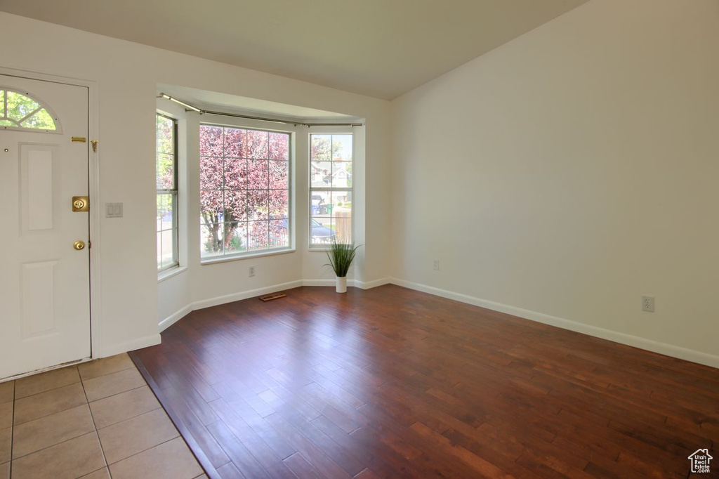 Entryway with wood finished floors and baseboards