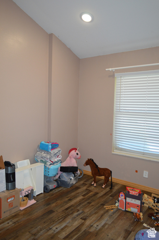 Playroom with wood finished floors and baseboards