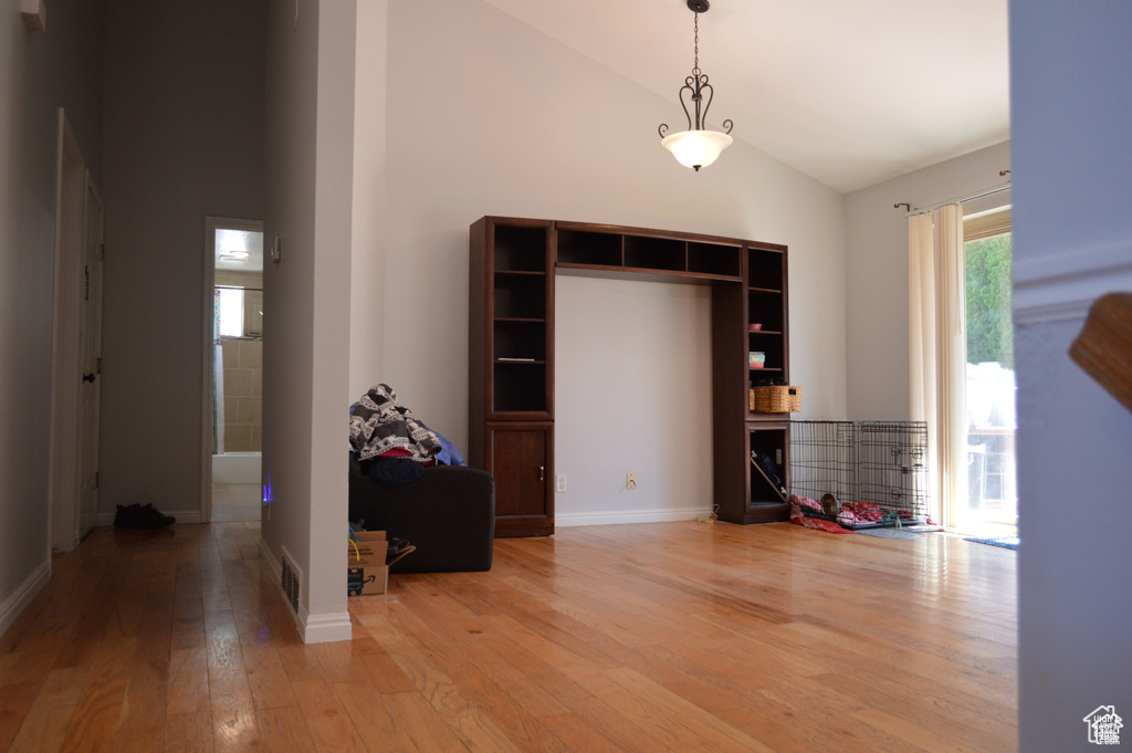 Dining room featuring high vaulted ceiling and light wood-style flooring