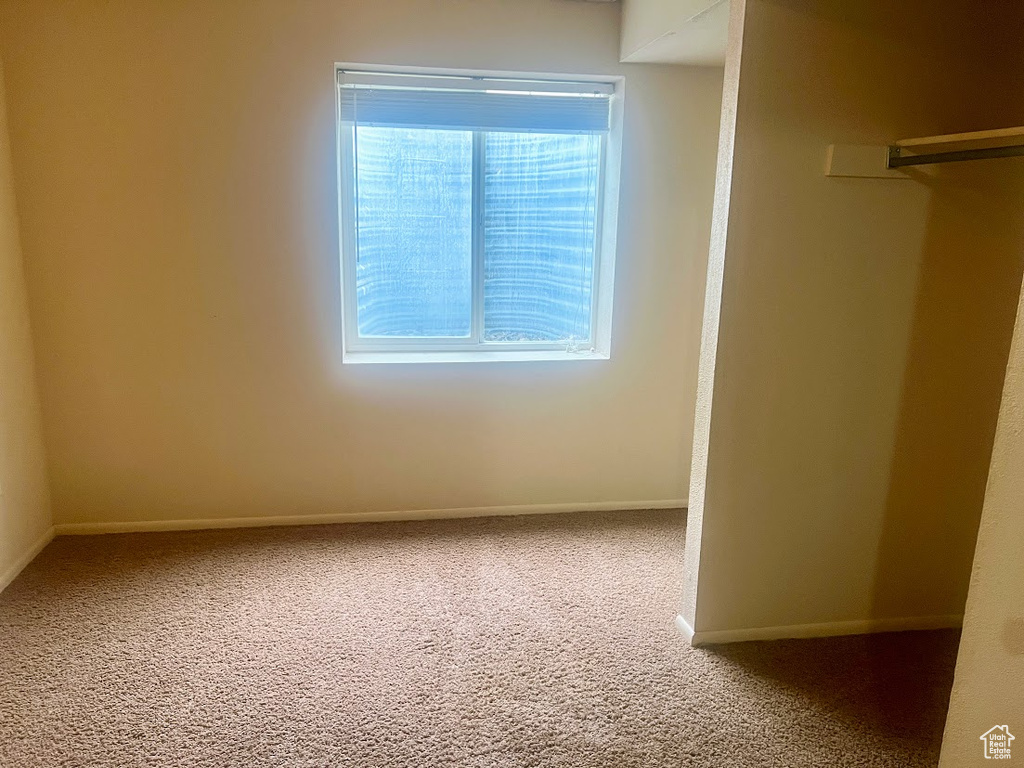 Carpeted empty room with baseboards