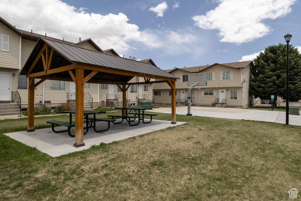 View of property's community featuring a gazebo, a lawn, and a residential view