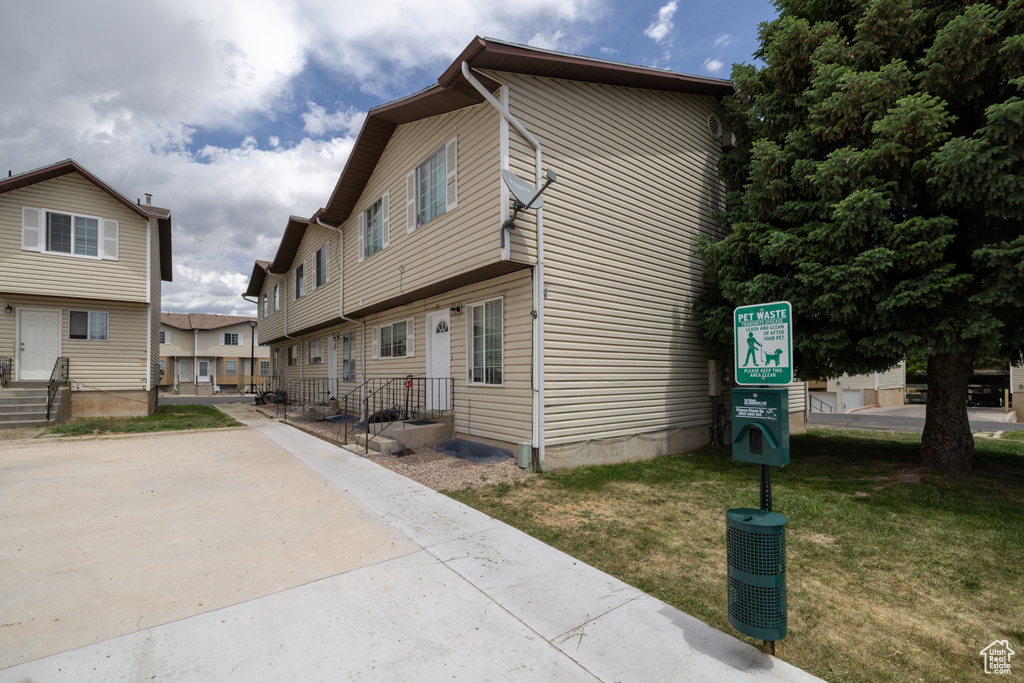 View of side of home featuring a yard