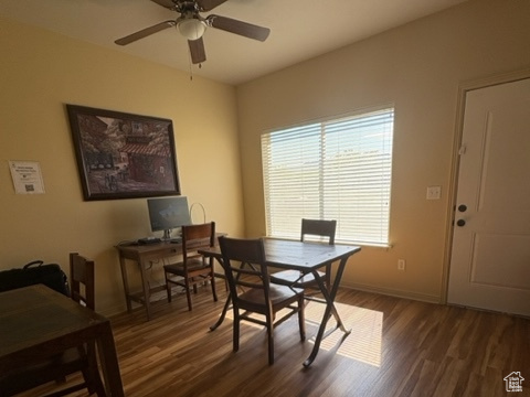 Dining space with dark wood finished floors and a ceiling fan