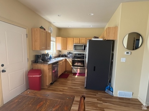 Kitchen with stainless steel appliances, dark wood finished floors, and recessed lighting