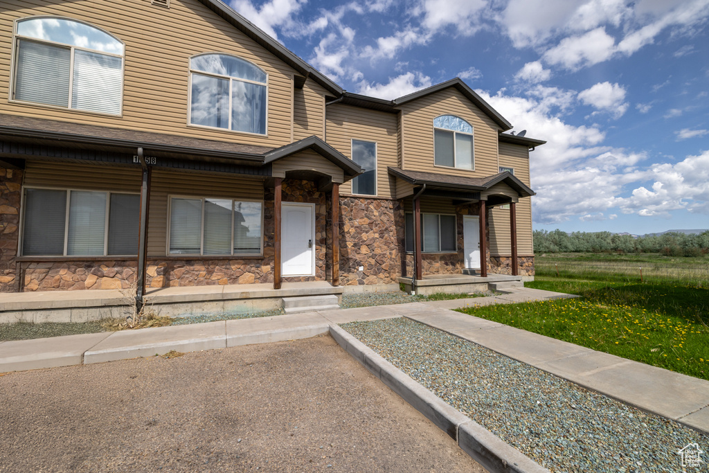 View of property with stone siding