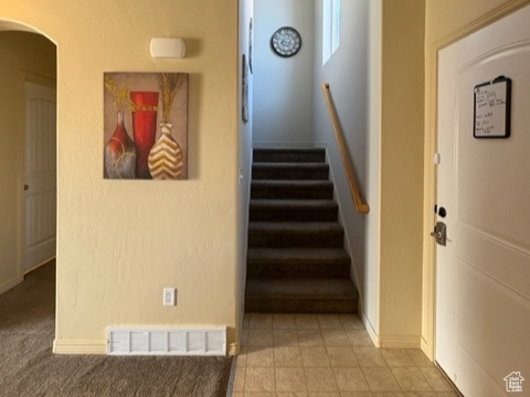 Stairs featuring arched walkways and baseboards
