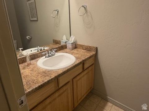 Bathroom featuring vanity and baseboards