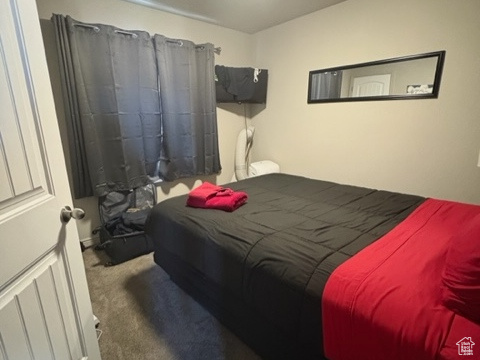 Bedroom with carpet and a textured ceiling