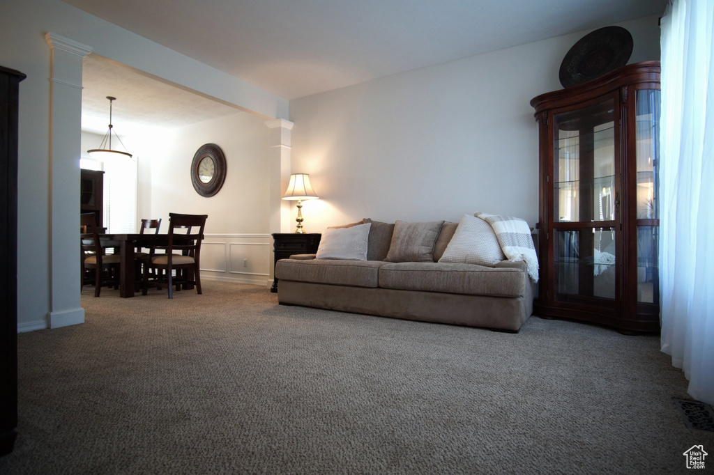 Living room featuring carpet flooring and wainscoting