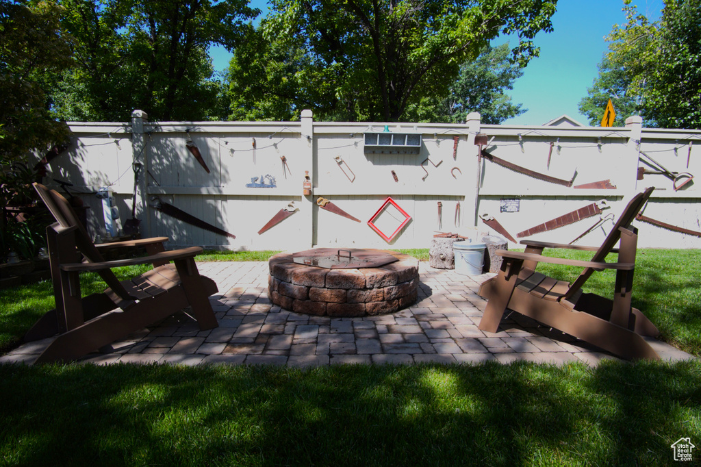 View of patio featuring an outdoor fire pit