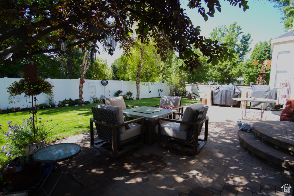 View of patio featuring area for grilling and outdoor dining space