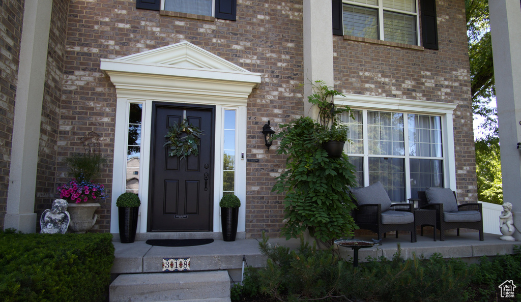 Doorway to property with brick siding