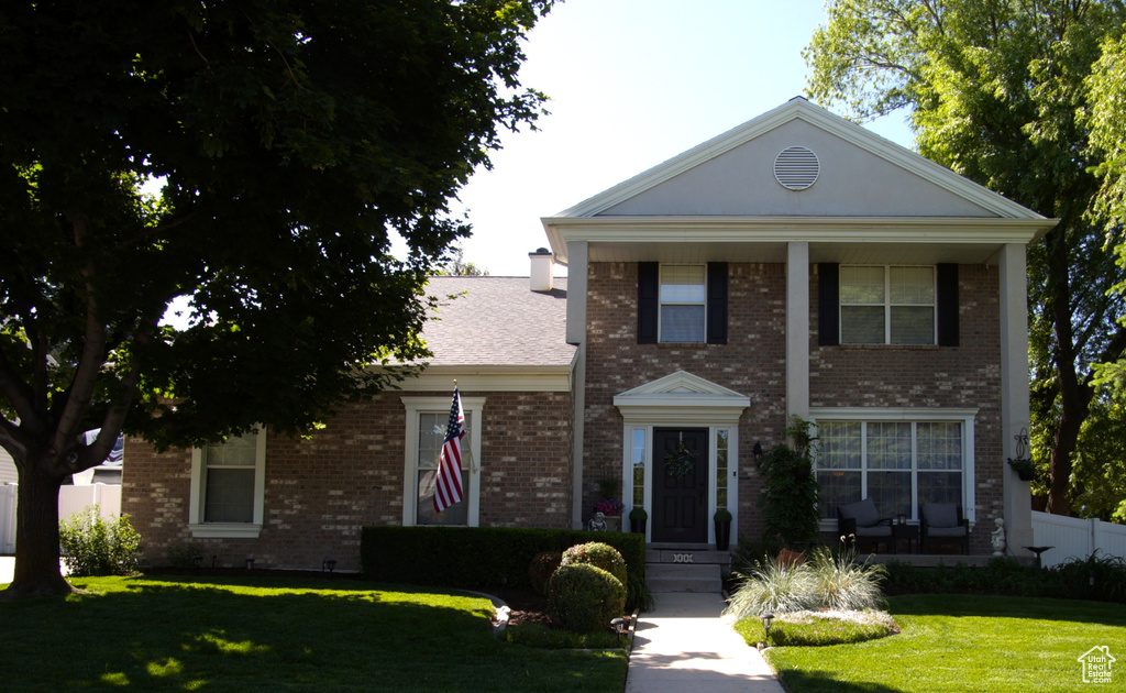 Neoclassical home with brick siding