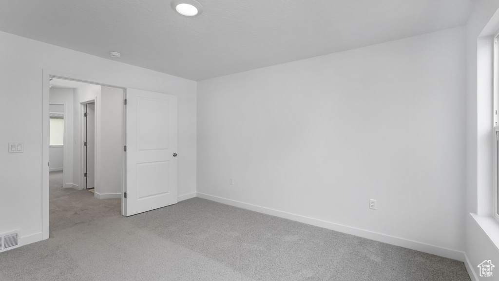 Unfurnished bedroom with carpet and baseboards