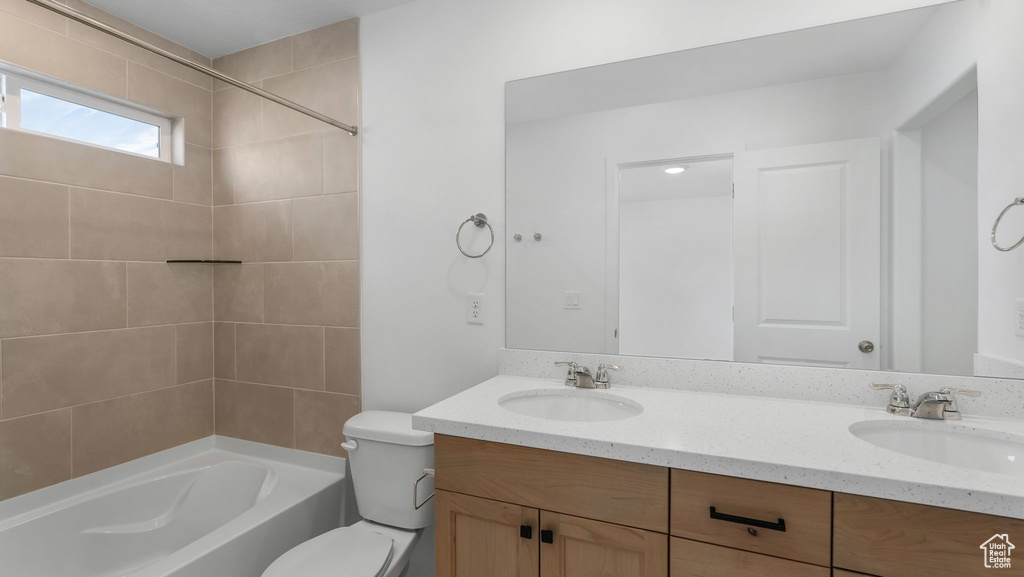 Full bath featuring double vanity and bathtub / shower combination