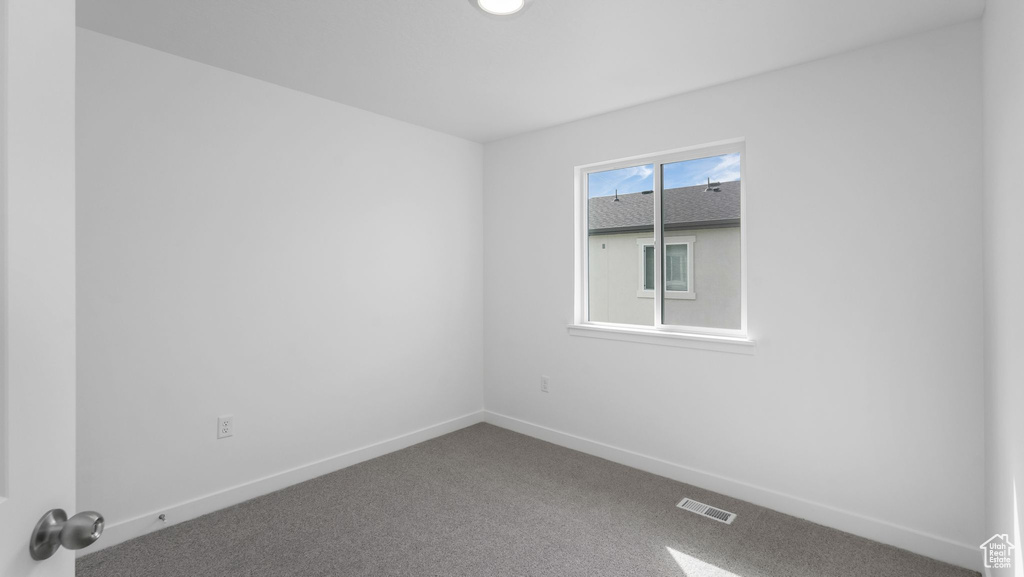 Empty room with carpet floors and baseboards