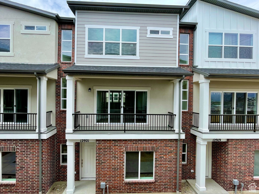 View of front of home featuring stucco siding and brick siding
