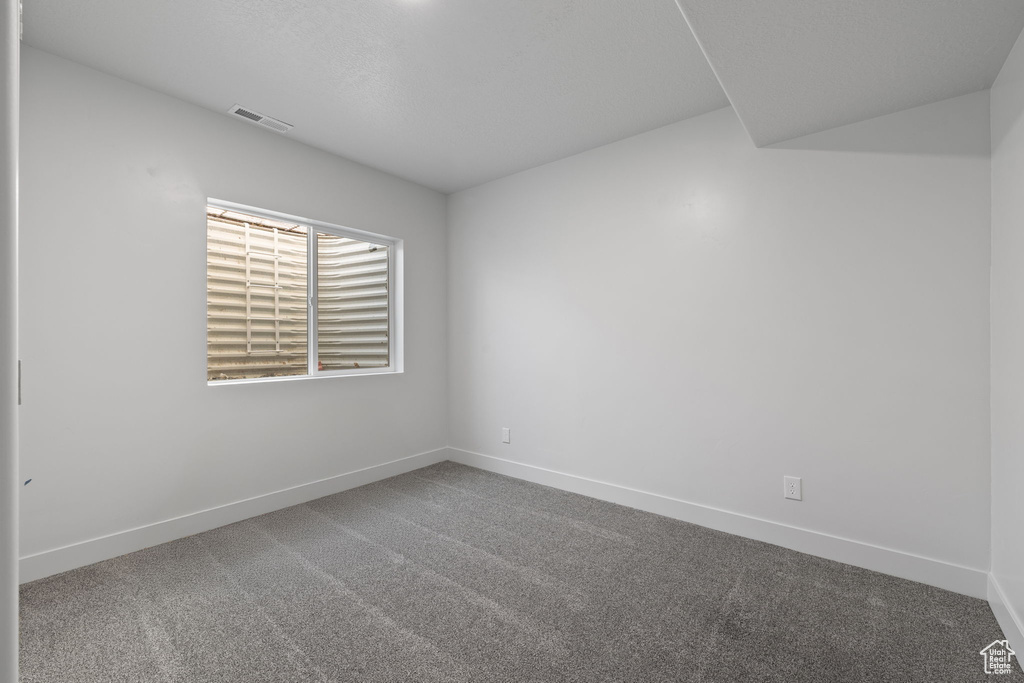 Carpeted spare room with baseboards