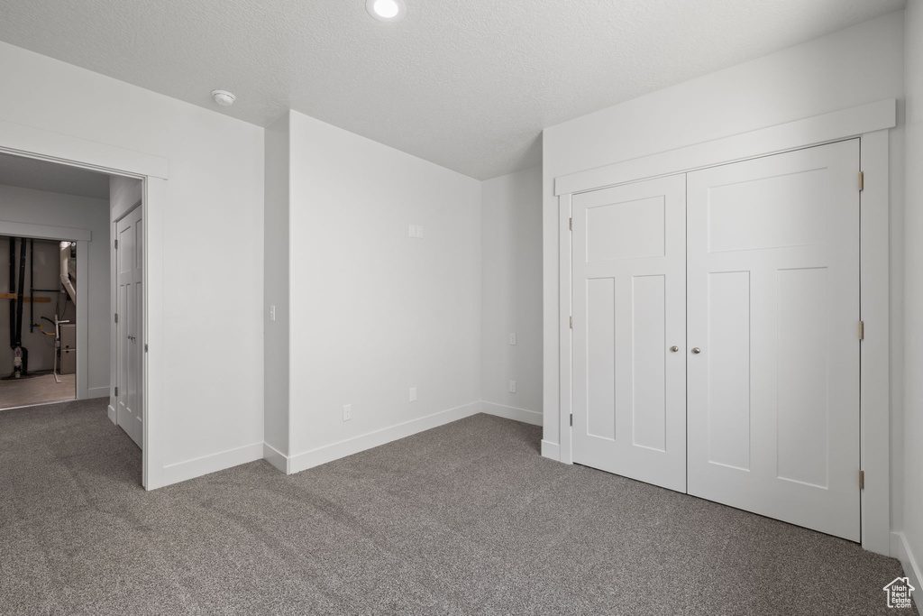 Unfurnished bedroom featuring carpet floors and a closet