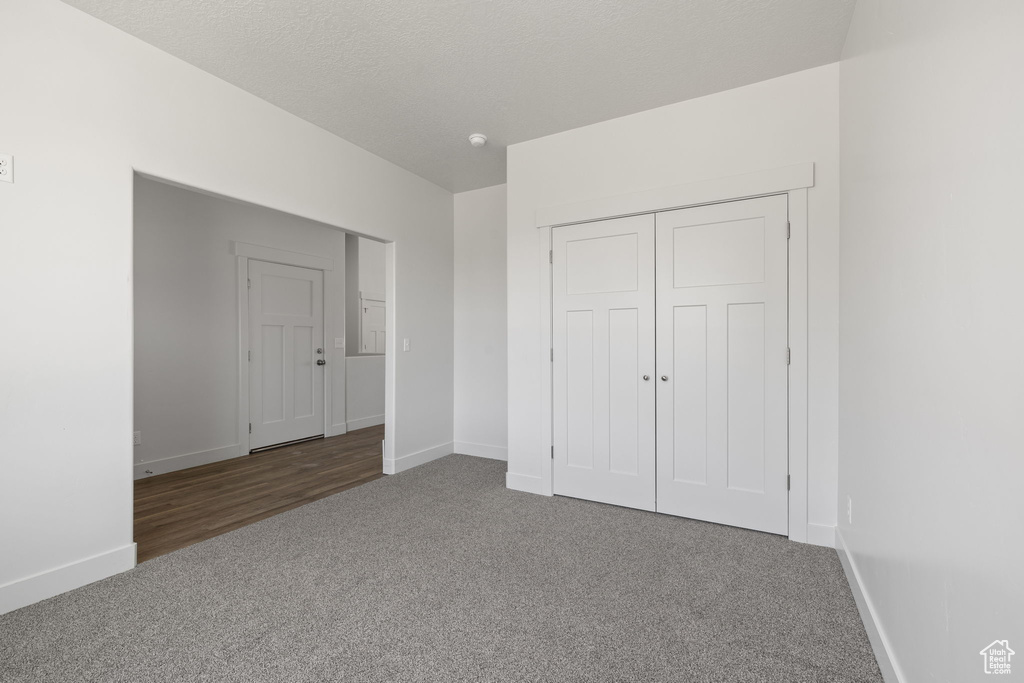 Unfurnished bedroom with carpet floors and a closet