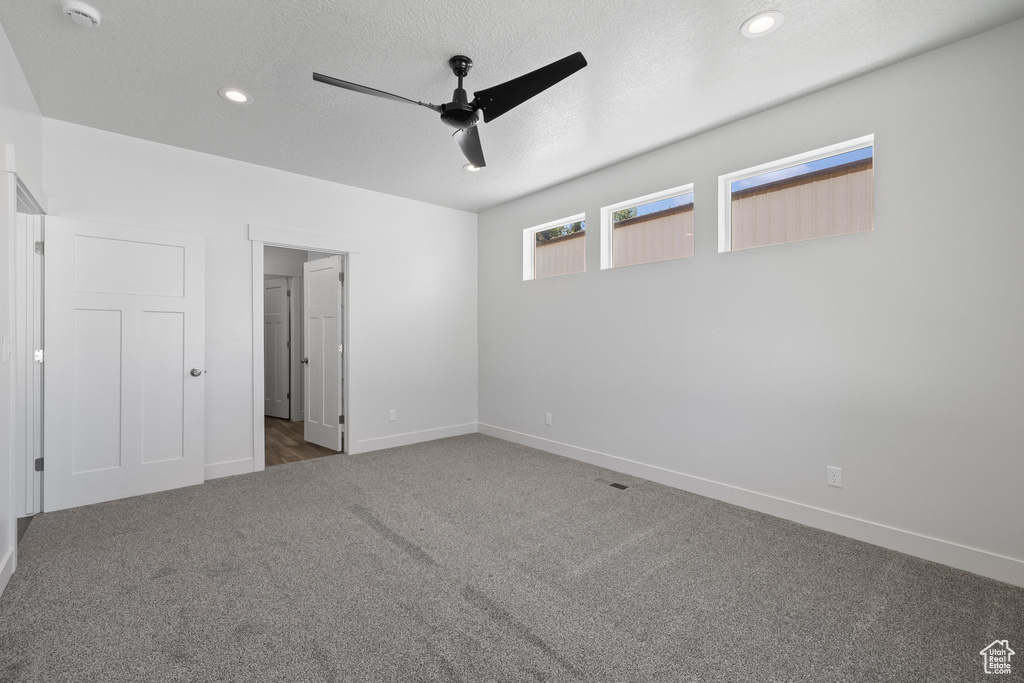 Unfurnished bedroom featuring carpet, a textured ceiling, ceiling fan, and recessed lighting