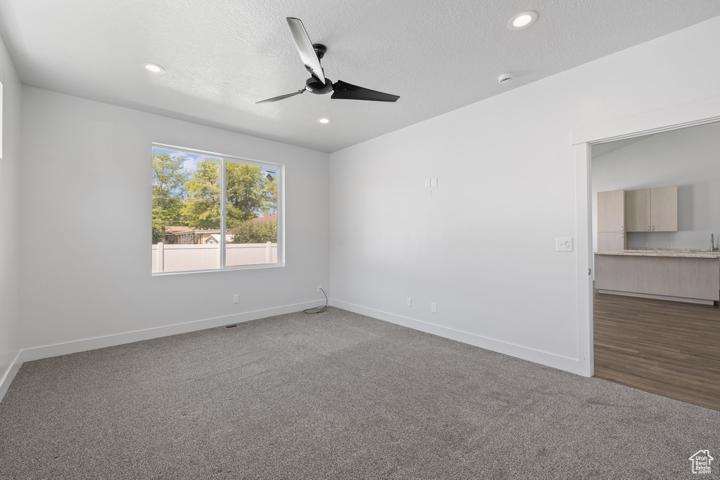 Unfurnished room featuring ceiling fan, carpet flooring, recessed lighting, and a textured ceiling