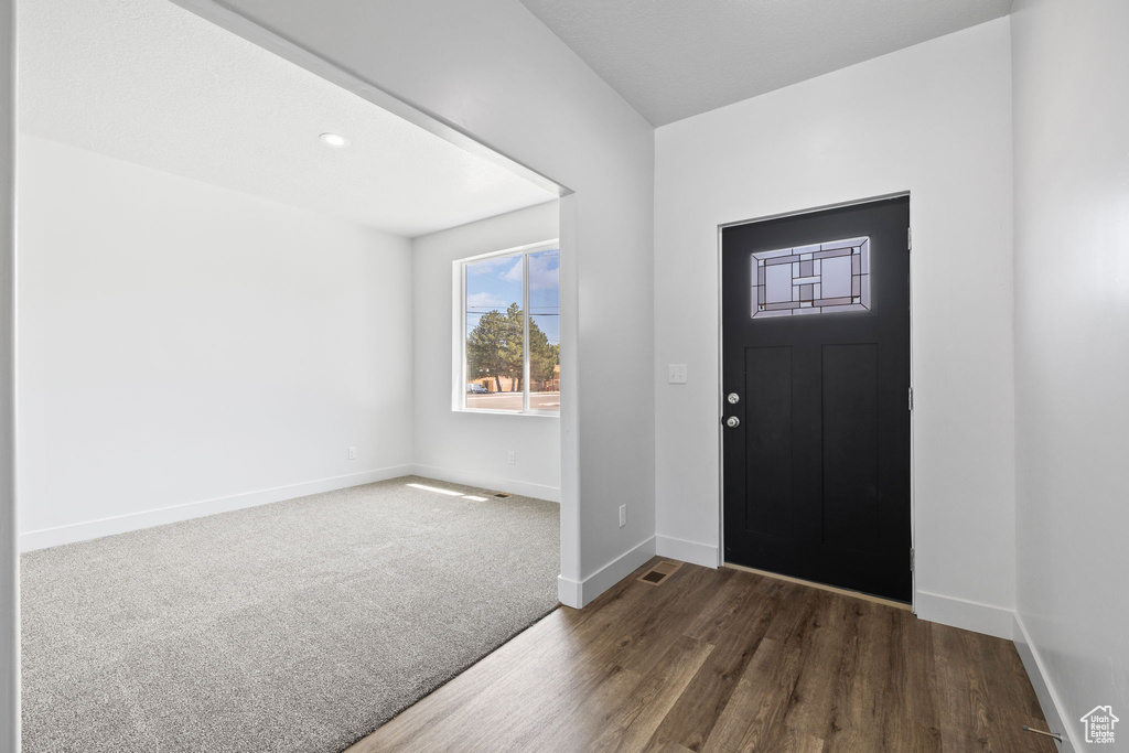 Foyer with wood finished floors and baseboards