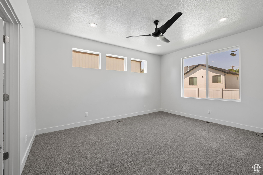Spare room with a textured ceiling, a ceiling fan, carpet flooring, and recessed lighting