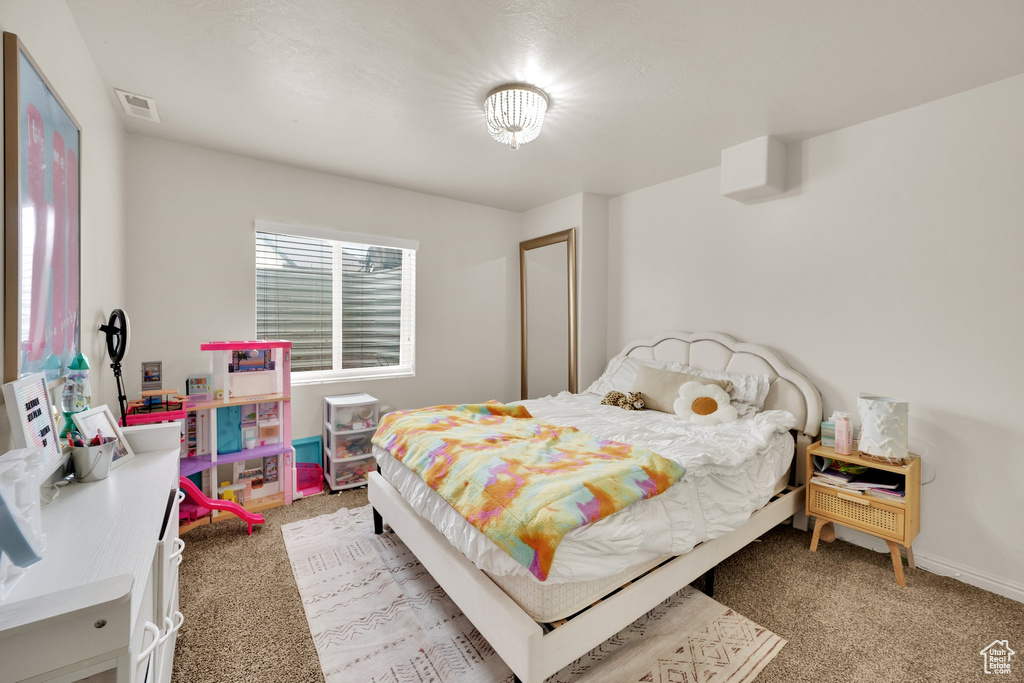 Bedroom featuring light carpet and baseboards