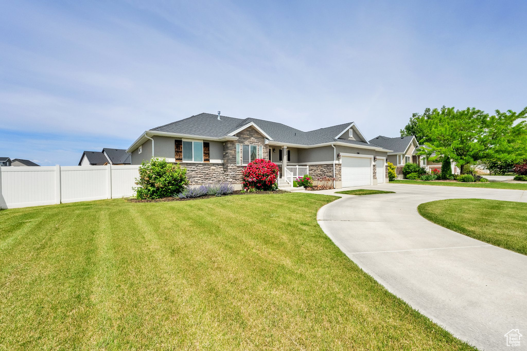 Ranch-style house with stone siding, a garage, and concrete driveway