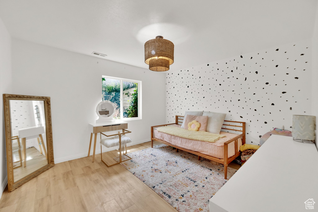 Bedroom with light wood finished floors and baseboards