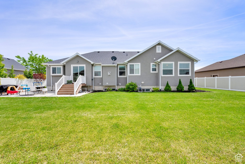 Rear view of property with a patio and stucco siding