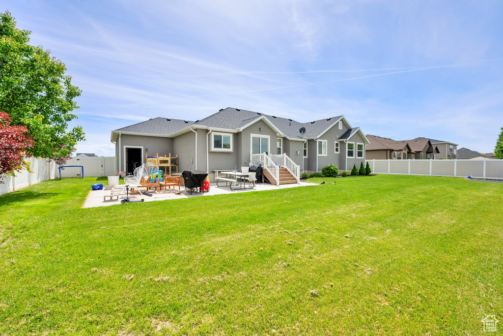 Back of house featuring a patio area and stucco siding