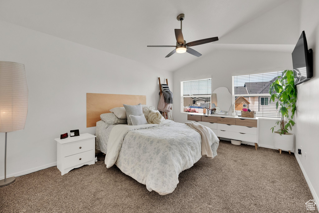 Bedroom with light carpet, lofted ceiling, baseboards, and ceiling fan